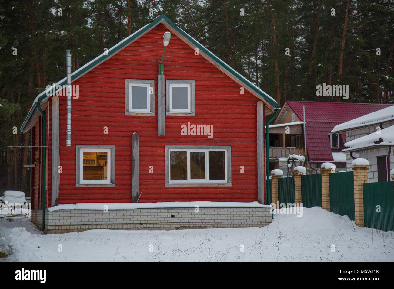 Maison en bois rouge hiver paysage de neige Banque D'Images