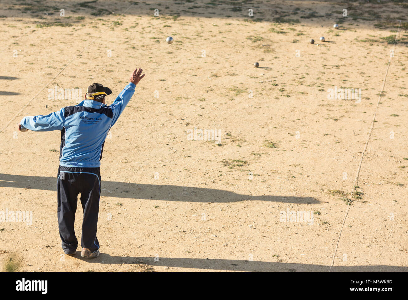Lagos, Algarve, Portugal - Février 25, 2018 : Senior man throwing Boule de petanque. Banque D'Images