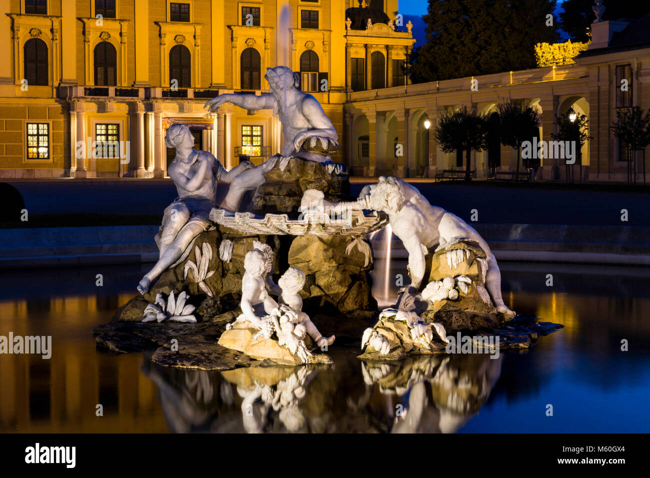 Le palais de Schönbrunn et l'une des Fontaines (esprits de Naiad sources et rivières) illuminé la nuit, Schonbrunn, Vienne, Autriche. Banque D'Images