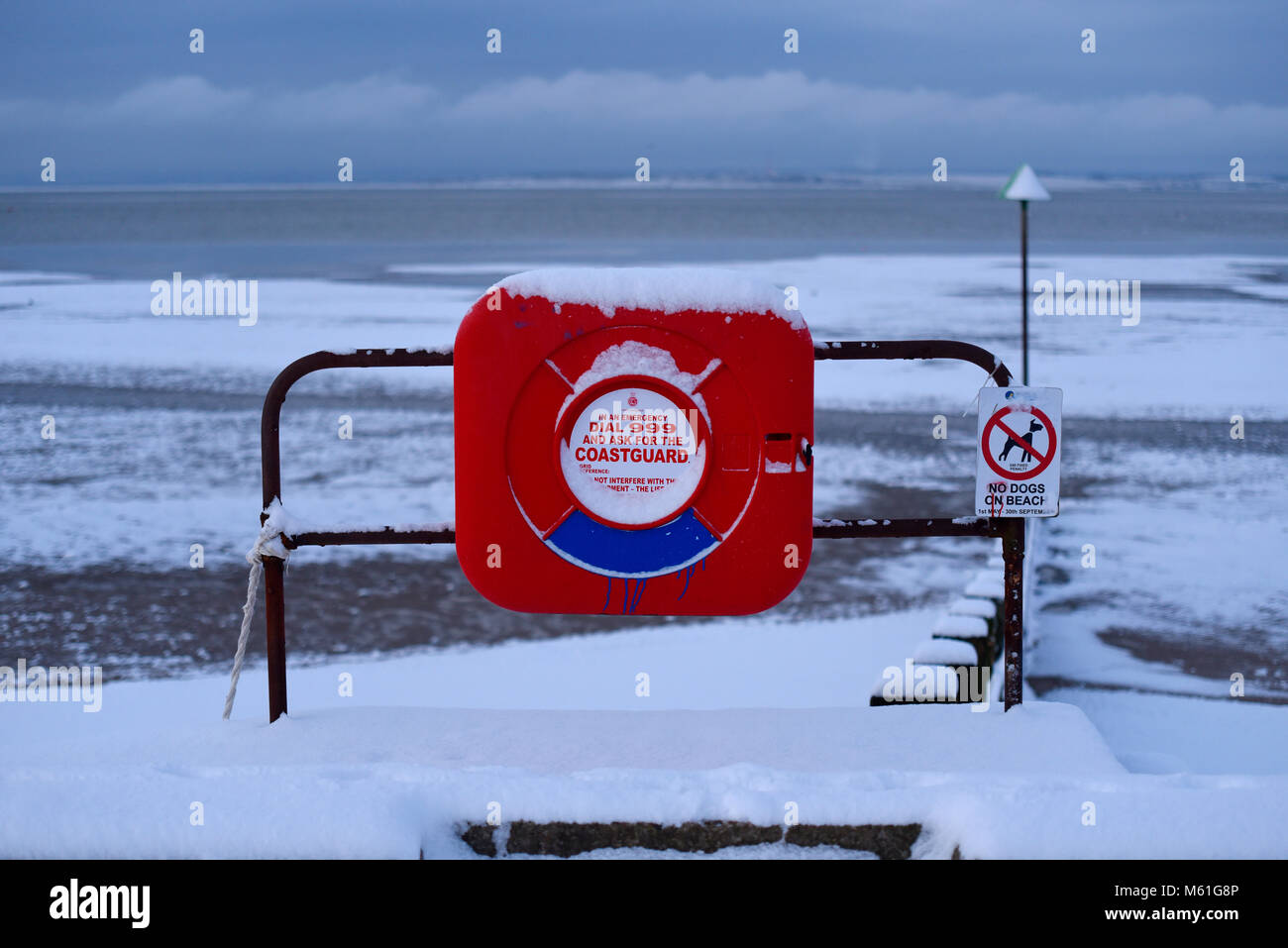 Bouée et Thames Estuary estran avec de la neige au cours de la bête de l'Est les phénomènes météorologiques. Composez le 999 pour les garde-côtes. Pas de chiens sur la plage Banque D'Images