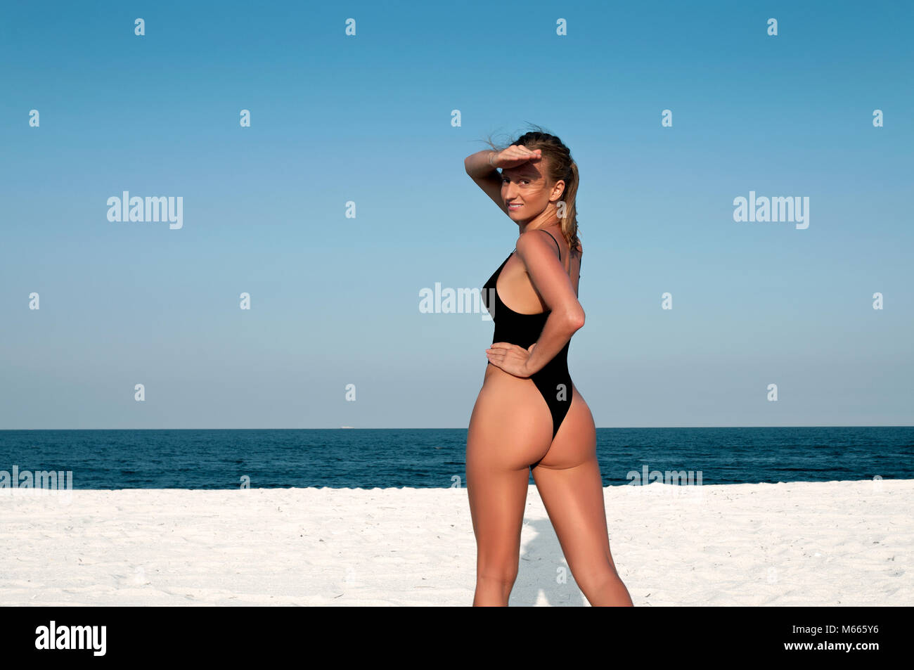 Belle femme en maillot noir sur la plage. Concept d'été Photo Stock - Alamy