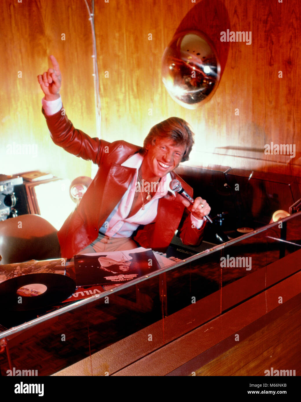 1970 SMILING MAN DISK JOCKEY PARLANT AU MICRO SUR LA CONSOLE AVEC DES ENREGISTREMENTS DE LA MUSIQUE DISCO - KT3119 HAR001 OCCUPATION HARS BONHEUR HIGH ANGLE INTERPRÈTE CARRIÈRES enthousiasme joyeux sourires artiste artistes ARTISTES POPULAIRES ACTEURS INTRODUCTION DISCOTHÈQUE MI-hommes mi-homme adulte ADULTES CAUCASIAN ETHNICITÉ disc jockey disc jockey de disque à l'ANCIENNE PROFESSION PERSONNES SPIN ENREGISTREMENTS Banque D'Images