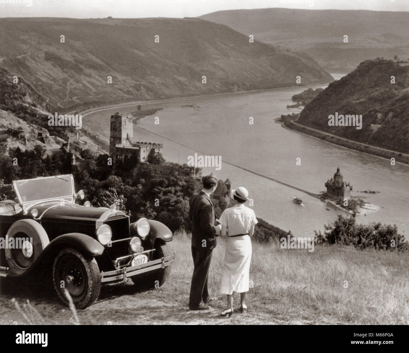 1930 COUPLE AVEC DES VOITURES DE TOURISME AVEC VUE SUR RHIN BURG PFALZGRAFENSTEIN CHÂTEAU GUTENFELS ET SUR L'ÎLE DE FALKENAU ALLEMAGNE - r390 HAR001 TRANSPORT HARS NOSTALGIE EUROPE SOLIDARITÉ 25-30 ans 30-35 ans 35-40 ans Femmes TOUR AVENTURE DÉTENTE LOISIRS ANGLE ÉLEVÉ AUTOS TOURISME TOURISTES CONNAISSANCES TENANT LA MAIN DE VÉHICULES AUTOMOBILES Les mâles adultes CHÂTEAUX MI-MID-ADULT MAN MID-ADULT WOMAN PACKARD B&W NOIR ET BLANC BURG CHÂTEAU GUTENFELS KAUB ETHNICITÉ CAUCASIEN FALKENAU ISLAND FALZ CHÂTEAU VIEUX JEU SUR LE RHIN PERSONNES PFALZGRAFENSTEIN Tourisme Tourisme Banque D'Images