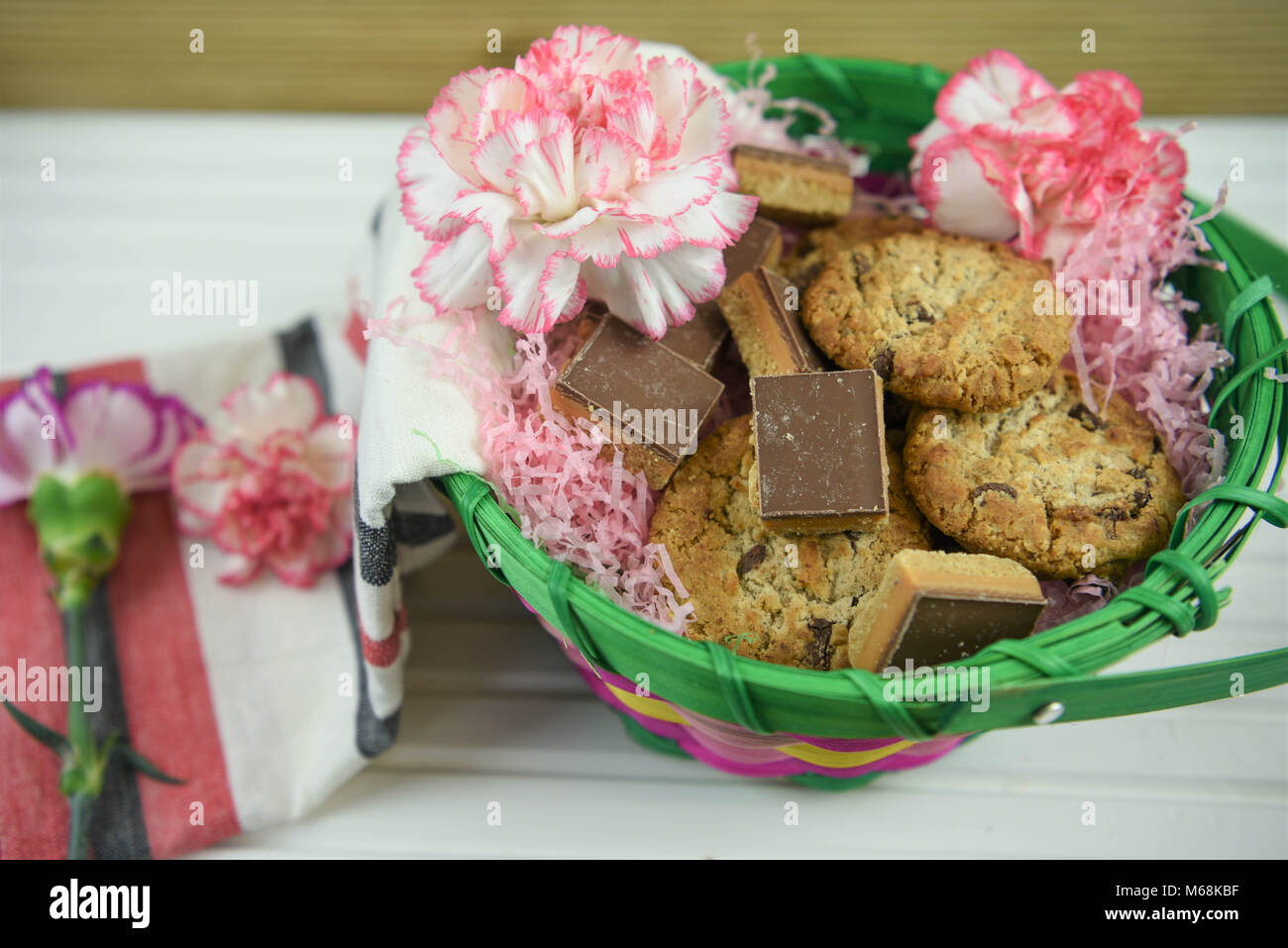 Beau cadeau alimentaire de cookies faits maison et des fleurs fraîches idéal pour un anniversaire ou la fête des mères, Pâques Banque D'Images