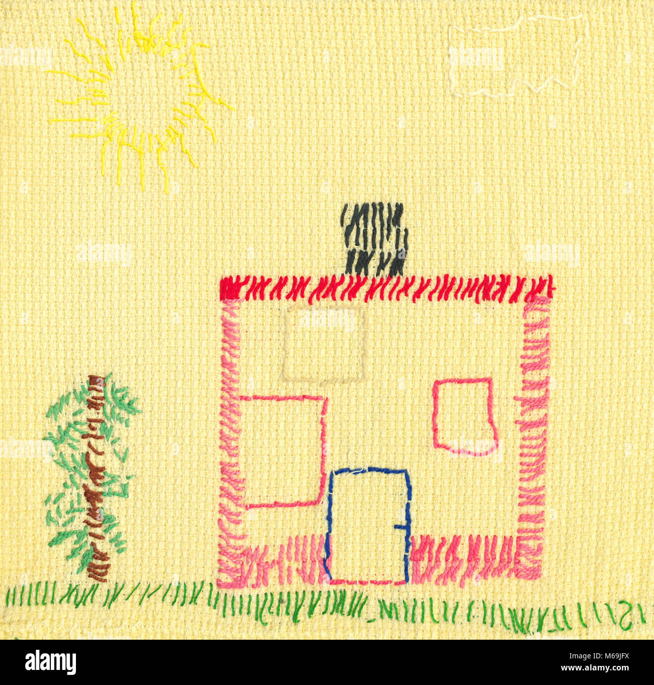 L'enfant broderie sur tissu jaune. Maison et arbre. Banque D'Images