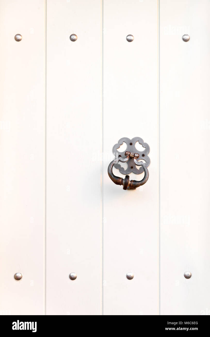 Heurtoir en métal sur la porte en bois blanc fermé Banque D'Images