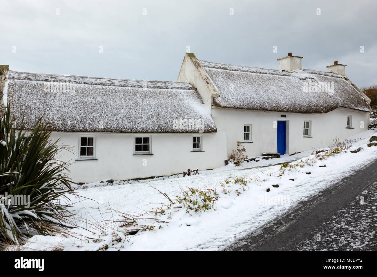 Irish cottage de chaume couvert de neige en pays lane le Valentia Island, comté de Kerry, Irlande Banque D'Images