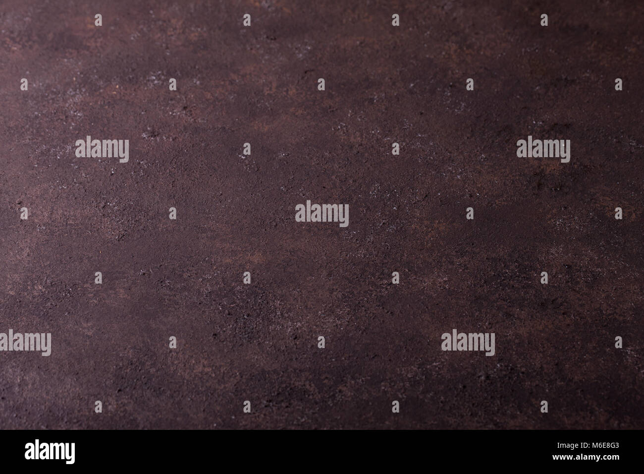La texture de surface de fond, boutons imitation béton poreux de fer rouillé. mur plat de couleur brun foncé, les boutons, l'exemplaire de l'espace. La texture de surface rugueuse Banque D'Images