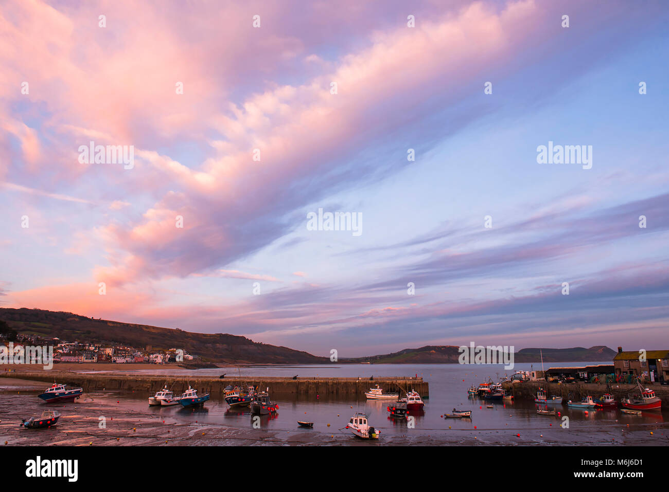 Auturmn dynamique des couleurs dans le ciel de Lyme Regis au coucher du soleil. Banque D'Images