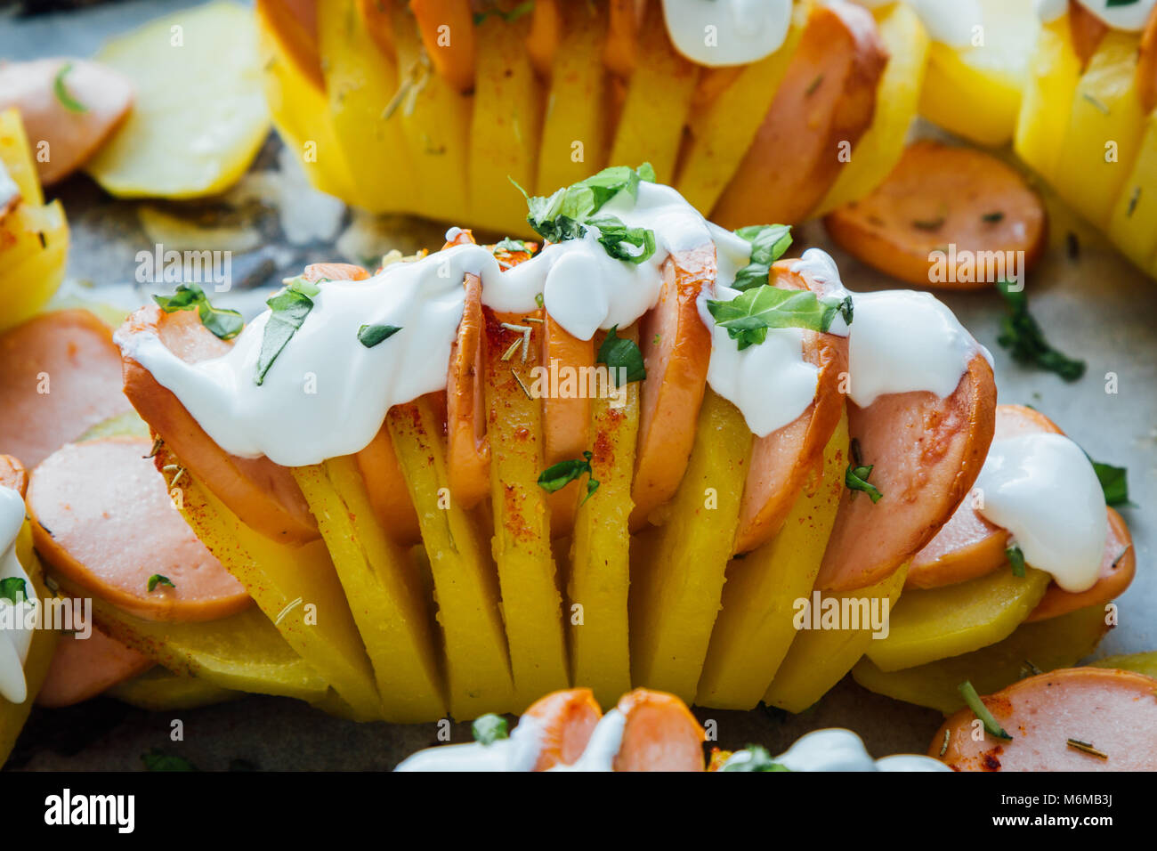 Pommes de terre au four avec de la saucisse et hasselback crème Banque D'Images