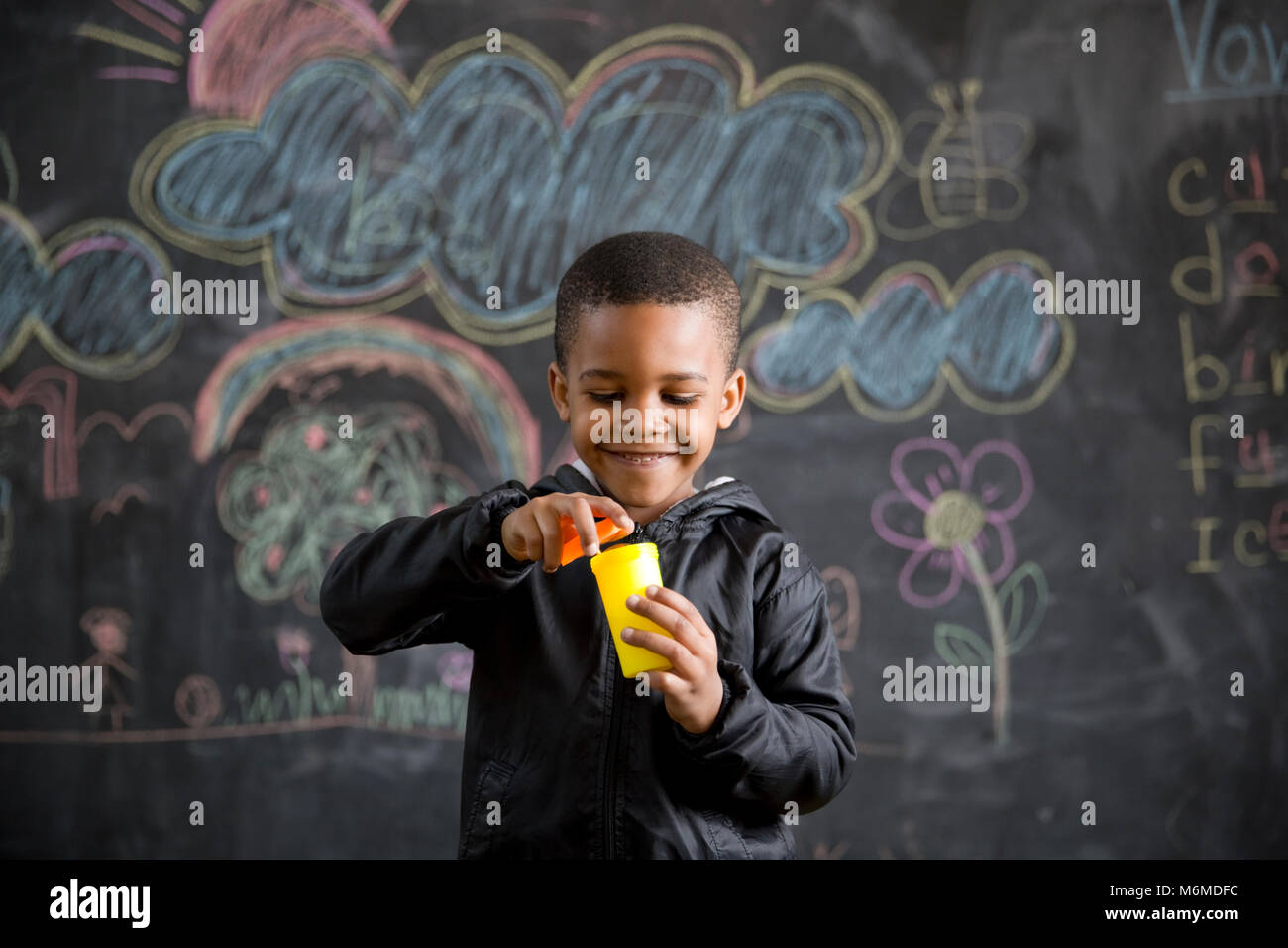 School boy blowing bubbles in class Banque D'Images