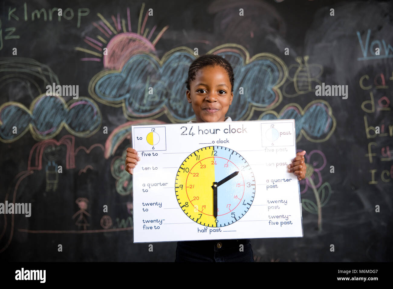School girl holding a clock Banque D'Images