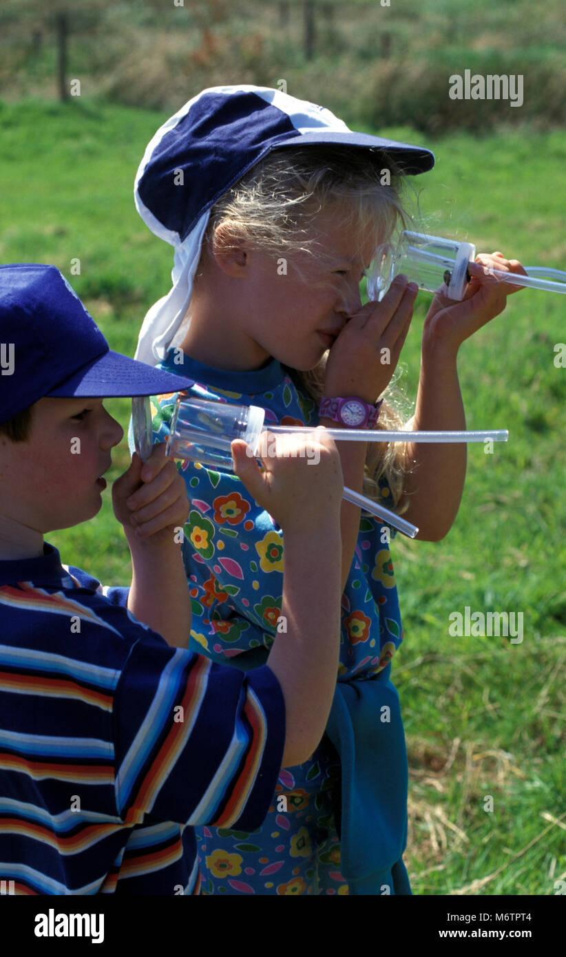Deux enfants à la recherche de bugs par pooter Banque D'Images