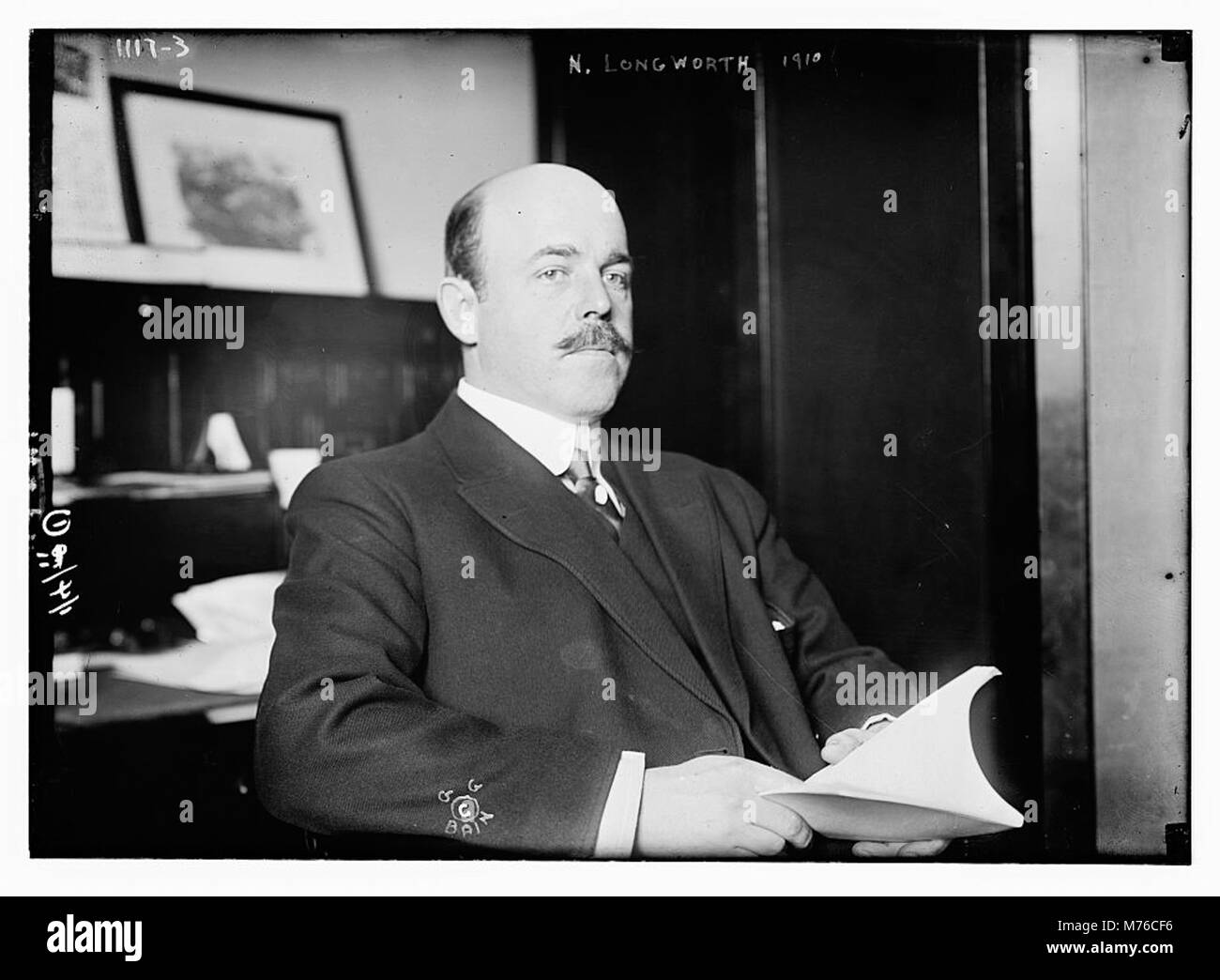 Un portrait de N. Longworth assis tout en tenant un livre, capturant un moment de réflexion tranquille. L'image se concentre sur le comportement de Longworth, mettant en valeur une pose calme et intellectuelle. Banque D'Images