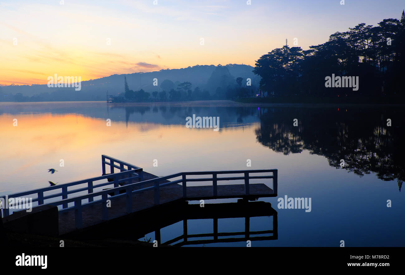 Destination de Voyage Vietnam à Da Nang city, le brouillard s'évaporer de l'eau de surface du lac, silhouette de petit pont réfléchir sur l'étang, belle au lever du soleil Banque D'Images