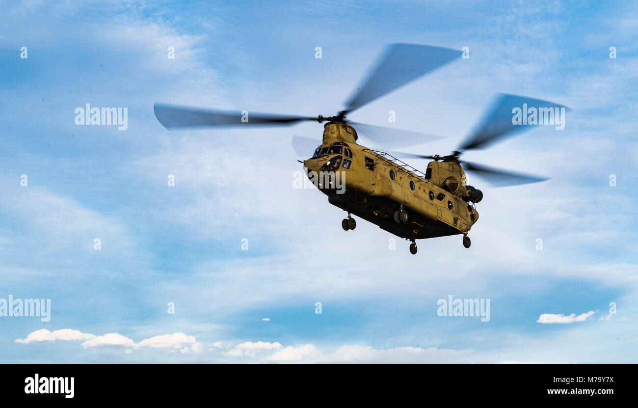 Un groupe de travail de l'armée américaine sont tumultueuses CH-47F Chinook vole lors d'une récupération du personnel de l'exercice avec un ange gardien équipe chargée du 83e Escadron de sauvetage expéditionnaire de Bagram Airfield, l'Afghanistan, le 6 mars 2018. Les équipages de l'armée et la Force aérienne ange gardien les équipes ont mené l'exercice de construire le travail d'équipe et les procédures qu'ils fournissent la capacité de récupération du personnel mixte, contribuant à l'acheminement de l'airpower décisif pour le Commandement central américain. (U.S. Air Force Photo de Tech. Le Sgt. Gregory Brook) Banque D'Images