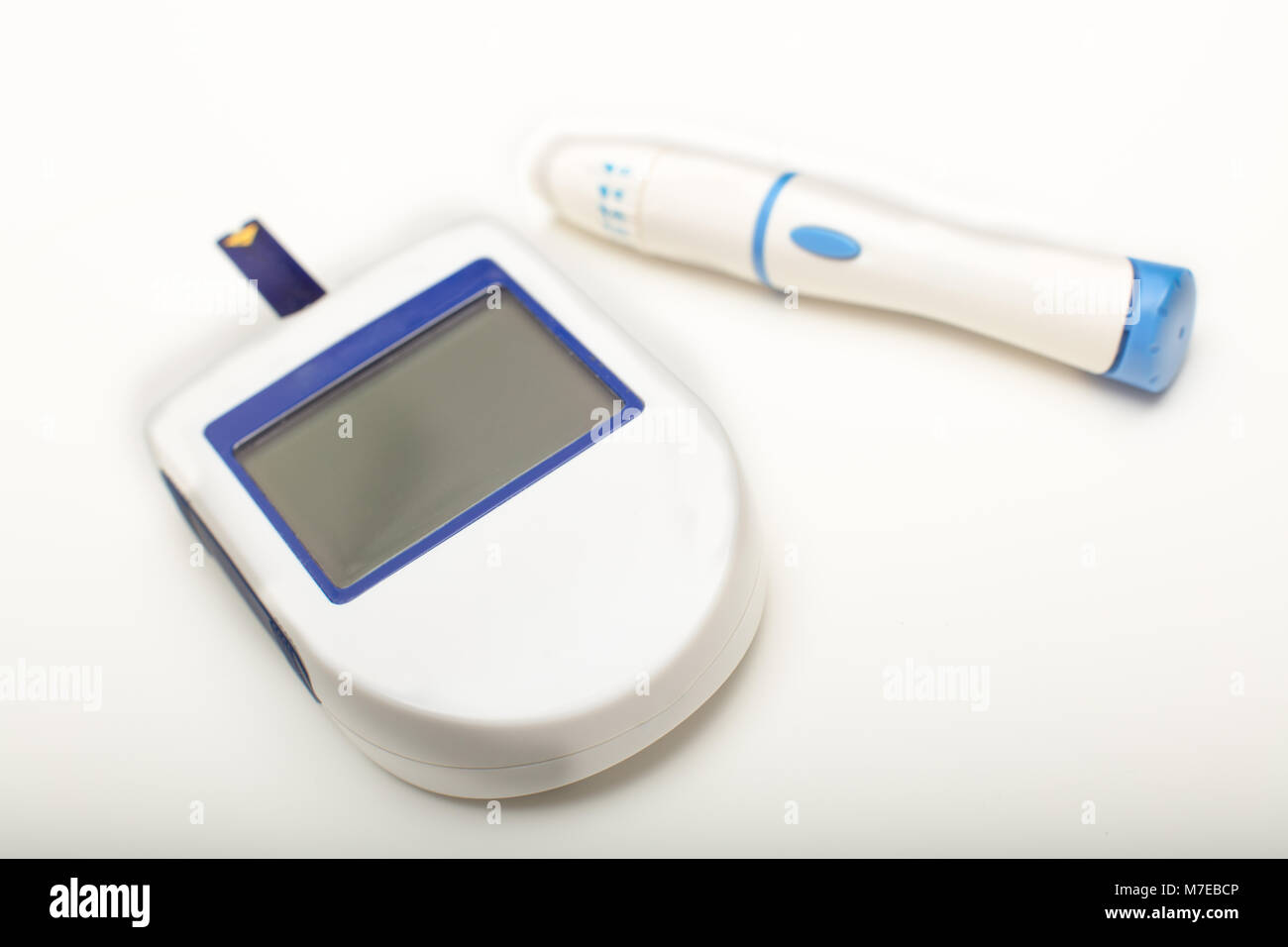 Glucomètre portable avec écran vide pour lire les niveaux de sucre dans le sang avec une lancette pour piquer un bout de doigt pour dessiner un échantillon de sang Banque D'Images