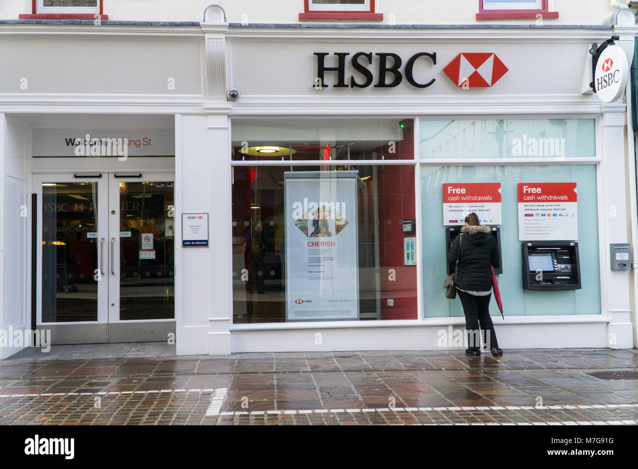 Femme Faire un retrait à partir d'un GAB de la banque HSBC,Jersey,Channel Islands Banque D'Images