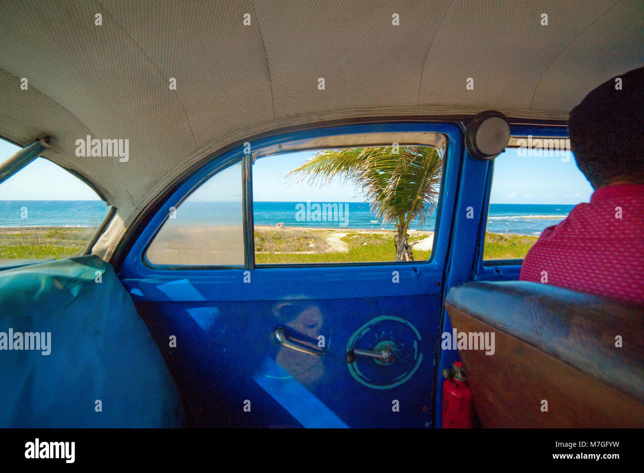 À l'intérieur d'un bleu classique taxi à La Havane, Cuba, avec une vue sur la mer des Caraïbes par la fenêtre Banque D'Images