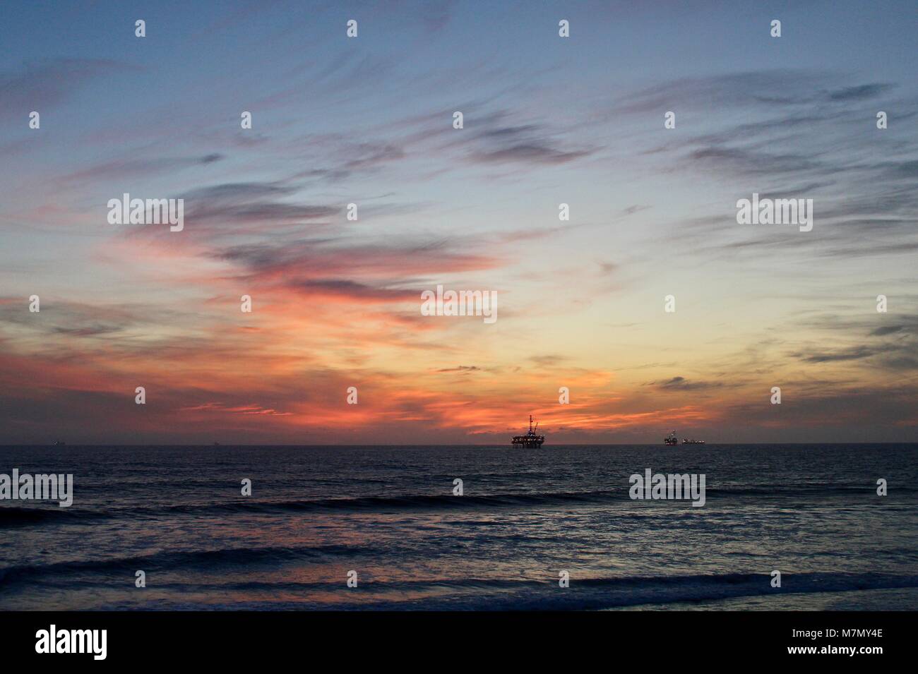 Nuageux coucher du soleil à la plage Banque D'Images