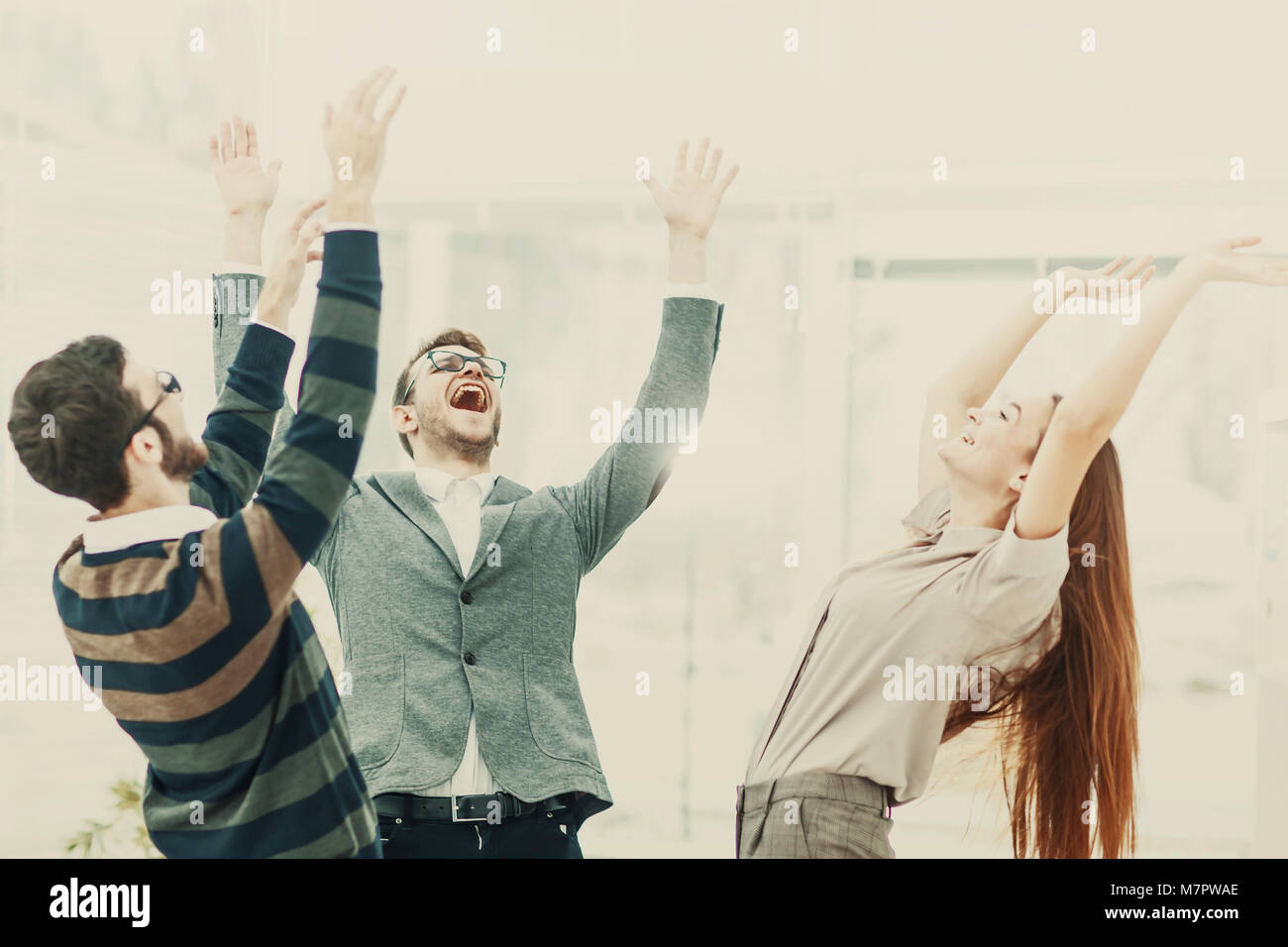 Notion de victoire - la fanfare l'équipe entreprises debout dans un cercle, les mains jusqu'à se réjouir du succès. Banque D'Images