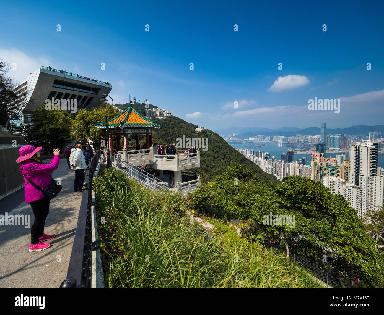 Hong Kong Les touristes prendre des photos de Hong Kong cityscape de Victoria Peak, avec la terrasse Sky plate-forme d'observation dans l'arrière-plan Banque D'Images