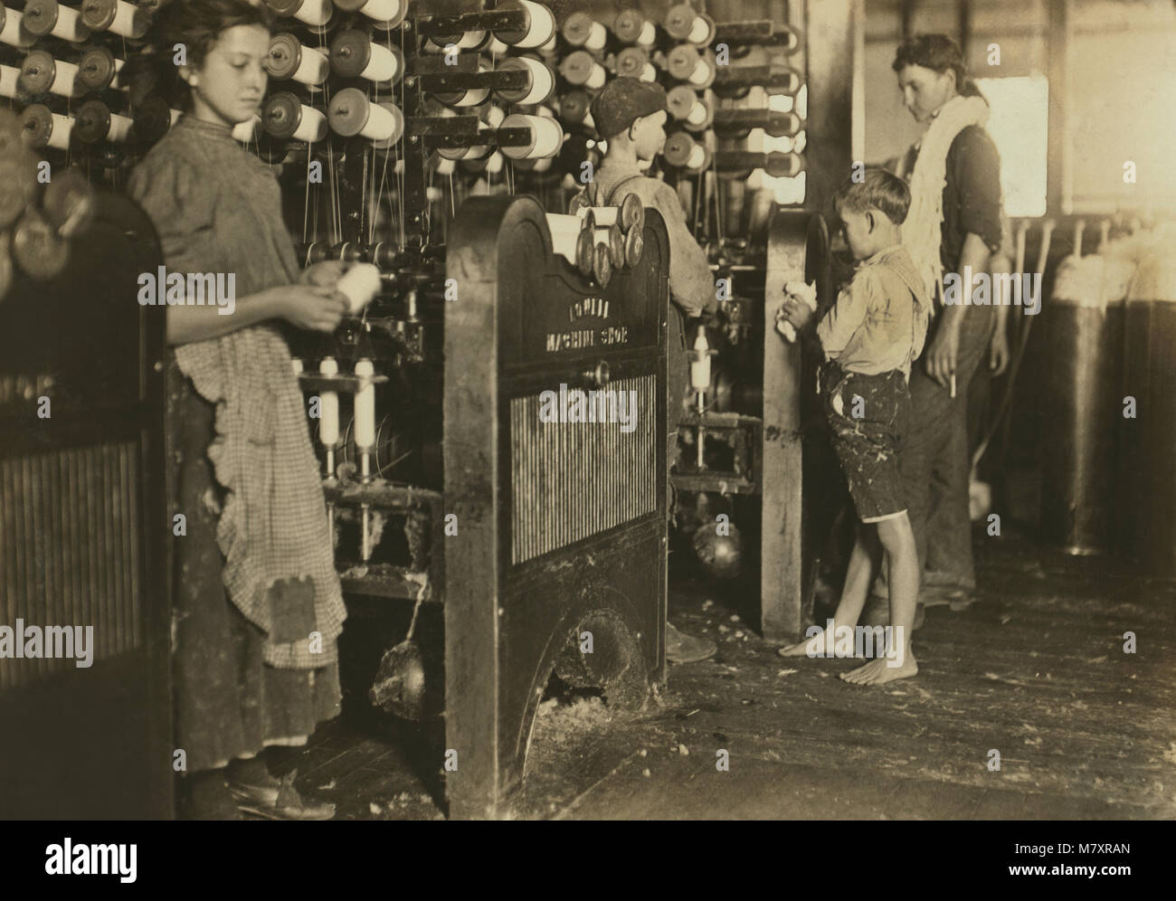 Jeune fille et les garçons qui travaillent dans l'usine de textile, Cherryville, North Carolina, USA, Lewis Hine pour Comité nationale sur le travail des enfants, Novembre 1908 Banque D'Images