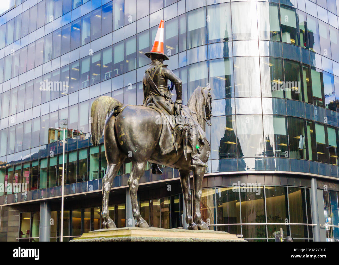 Statue du duc de Wellington avec un cône de circulation sur sa tête à califourchon sur un cheval en face de Goma, Royal Exchange Square, Glasgow. Érigée en 1844. Banque D'Images