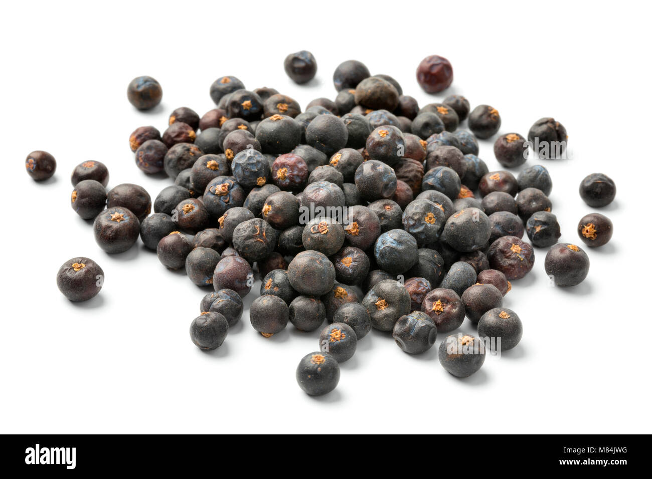 Tas de baies de genièvre séchées isolé sur fond blanc Banque D'Images