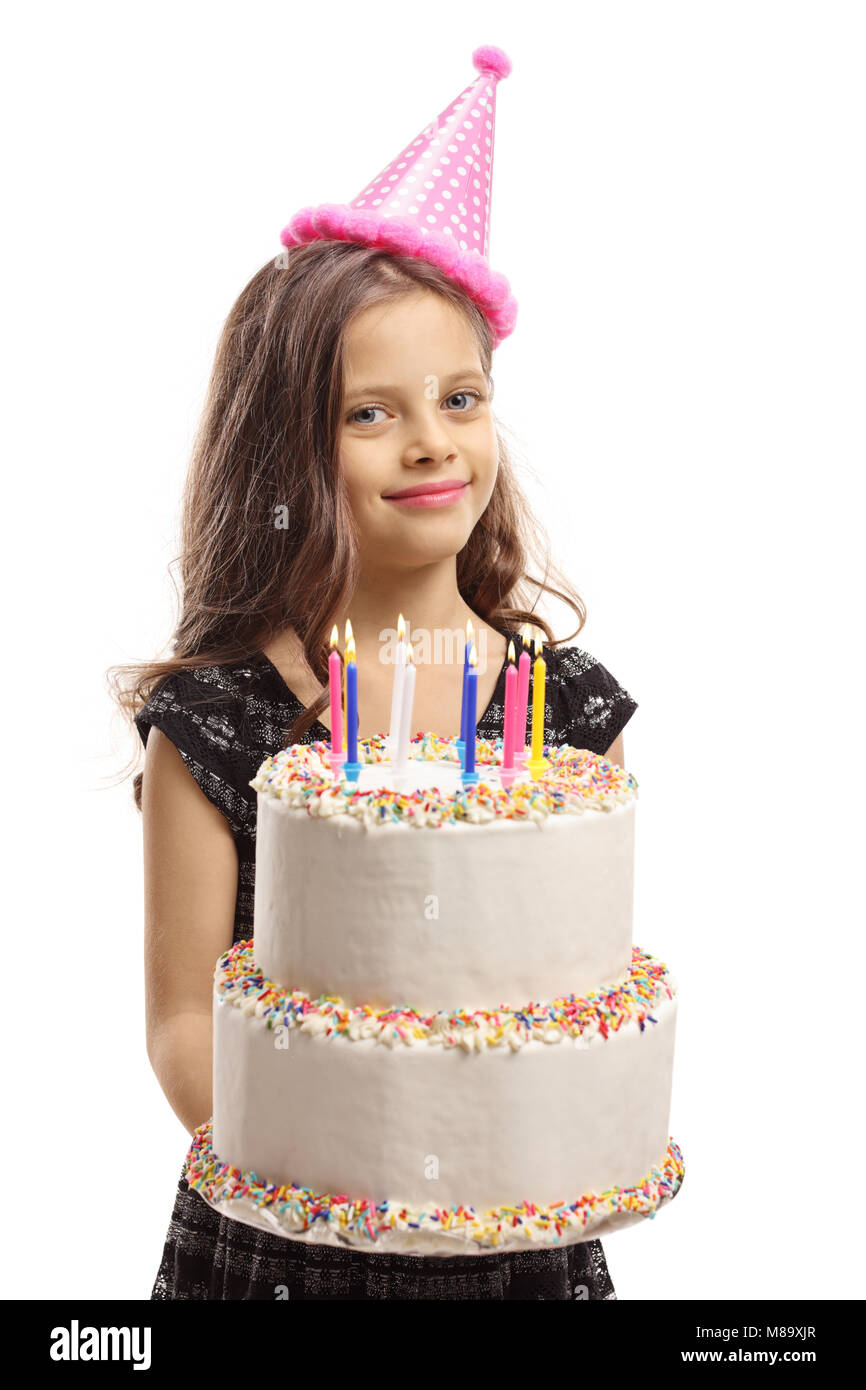Girl wearing a party hat holding a birthday cake isolé sur fond blanc Banque D'Images