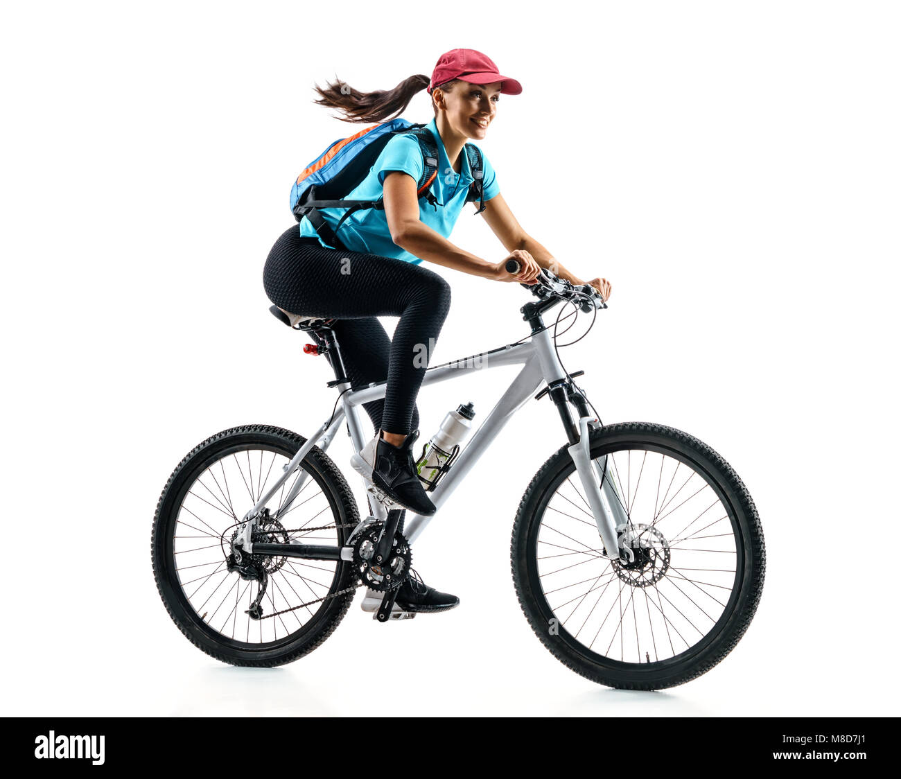 Cycliste en bleu t-shirt équitation le vélo en silhouette sur fond blanc. Le mouvement dynamique. Sport et mode de vie sain Banque D'Images