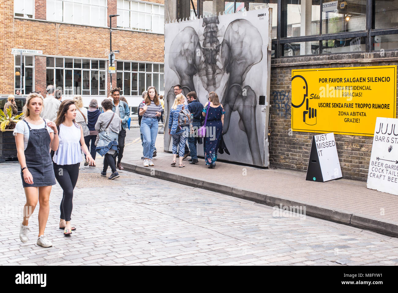 Les personnes bénéficiant de l'été chaud à l'Old Truman Brewery, Ely's Yard, Shoreditch, London, UK Banque D'Images