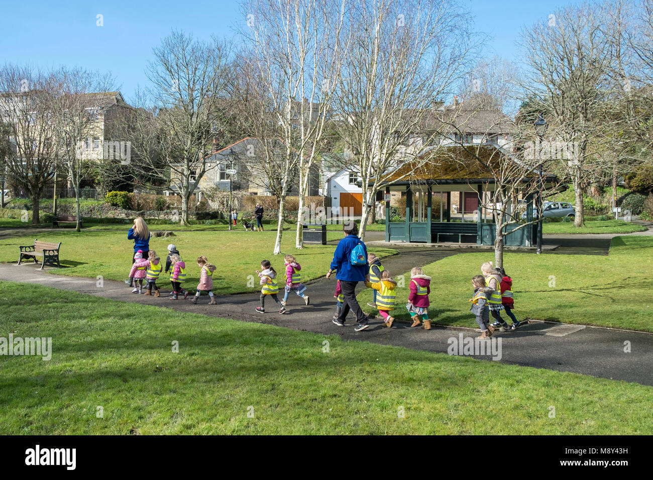 Les enfants d'une pépinière et leurs enseignants marcher si Trenance Gardens à Newquay Cornwall. Banque D'Images