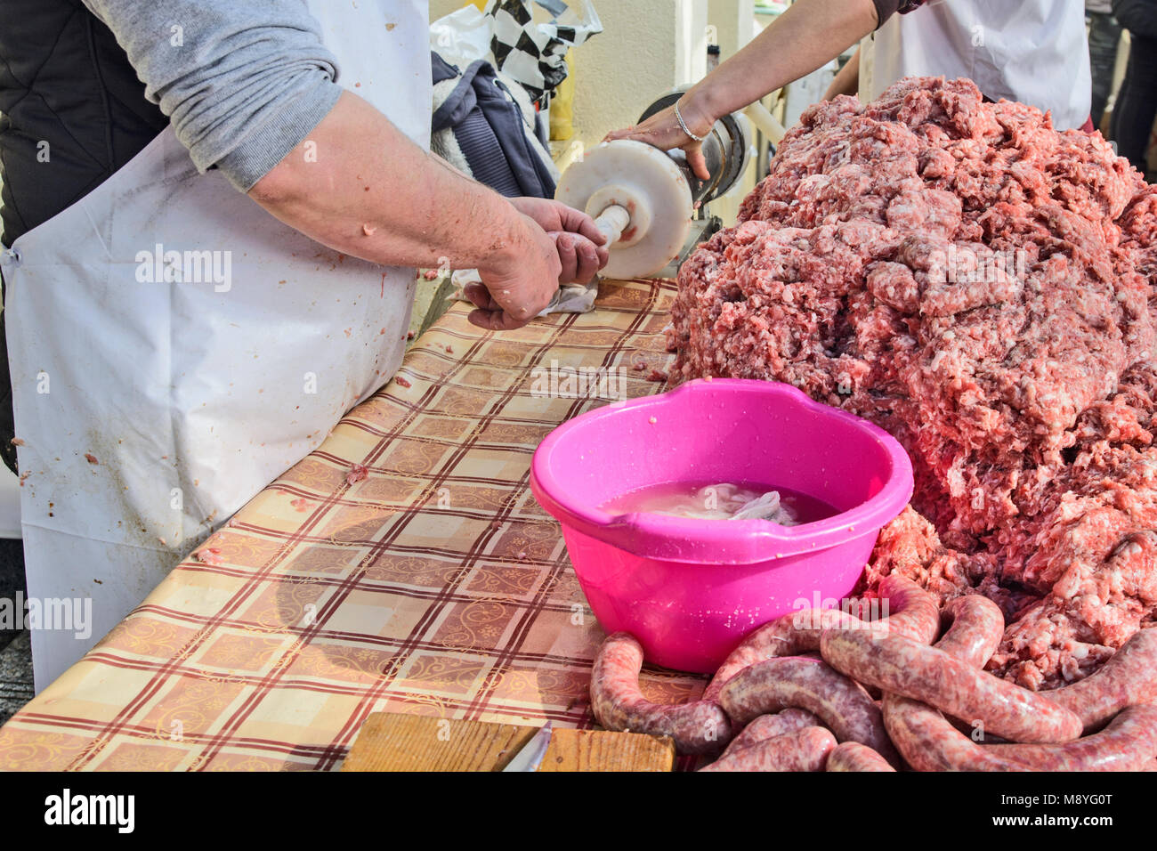 Le Boucher fait des saucisses en plein air de façon traditionnelle. Banque D'Images