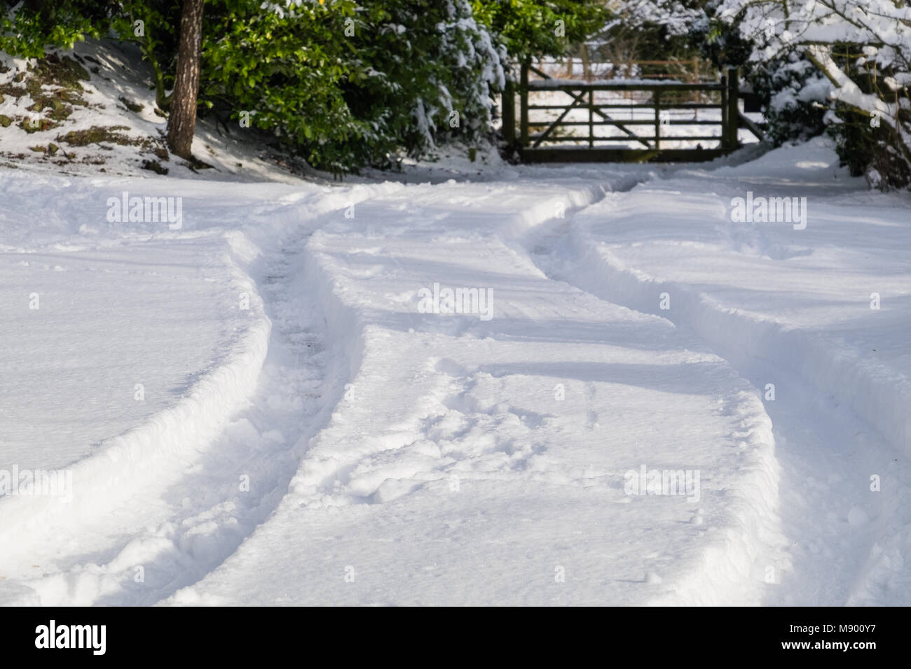 Location de pistes dans la neige menant à gate Banque D'Images