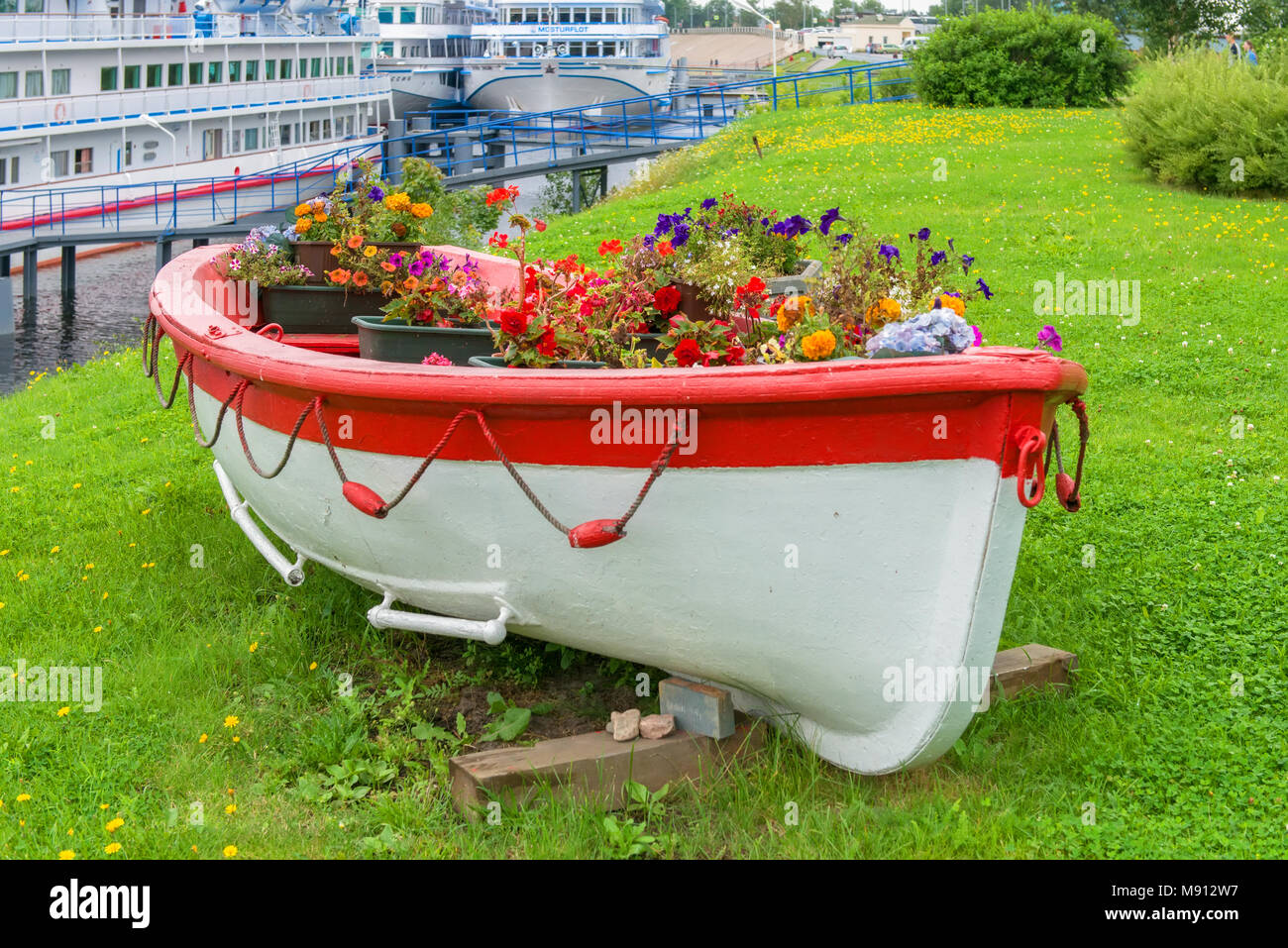 Modèle Vintage décoratif en bois ancien bateau de oar plein de fleurs. L'aménagement paysager Banque D'Images