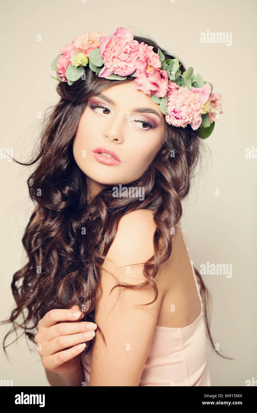 Floral doux Portrait de femme Fashion model. Cheveux bouclés, maquillage et beauté des fleurs de pivoine Banque D'Images