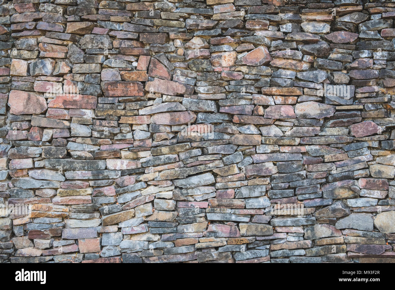 Mosaïque murale en pierre naturelle - construction pierre roche wall background Banque D'Images