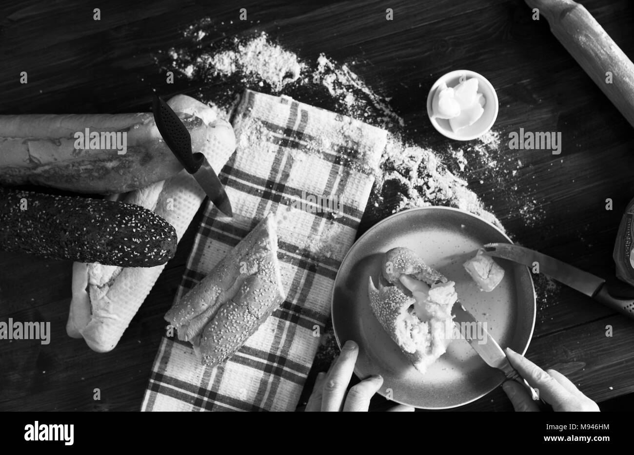 Du pain frais et des baguettes en bois sur une surface de travail de cuisine en noir et blanc Banque D'Images