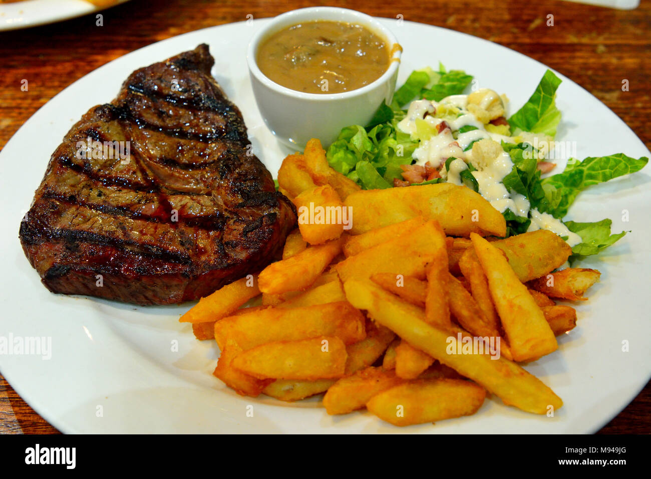 Assiette de steak de boeuf avec salade, frites et sauce aux champignons  Photo Stock - Alamy
