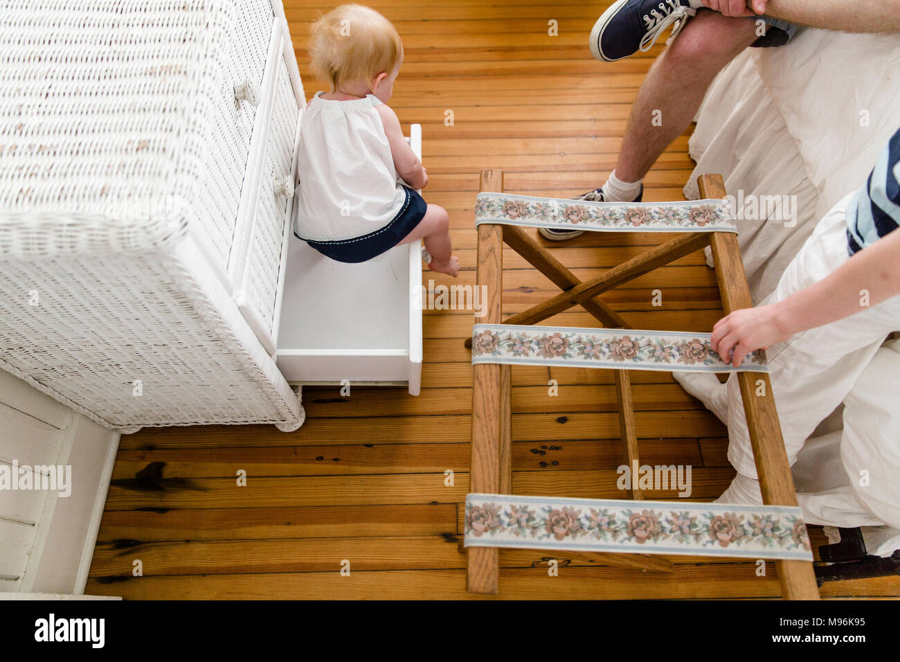 Escalade A L Interieur Des Tiroirs De Bebe Avec La Famille Sur Le Lit A Cote D Elle Photo Stock Alamy
