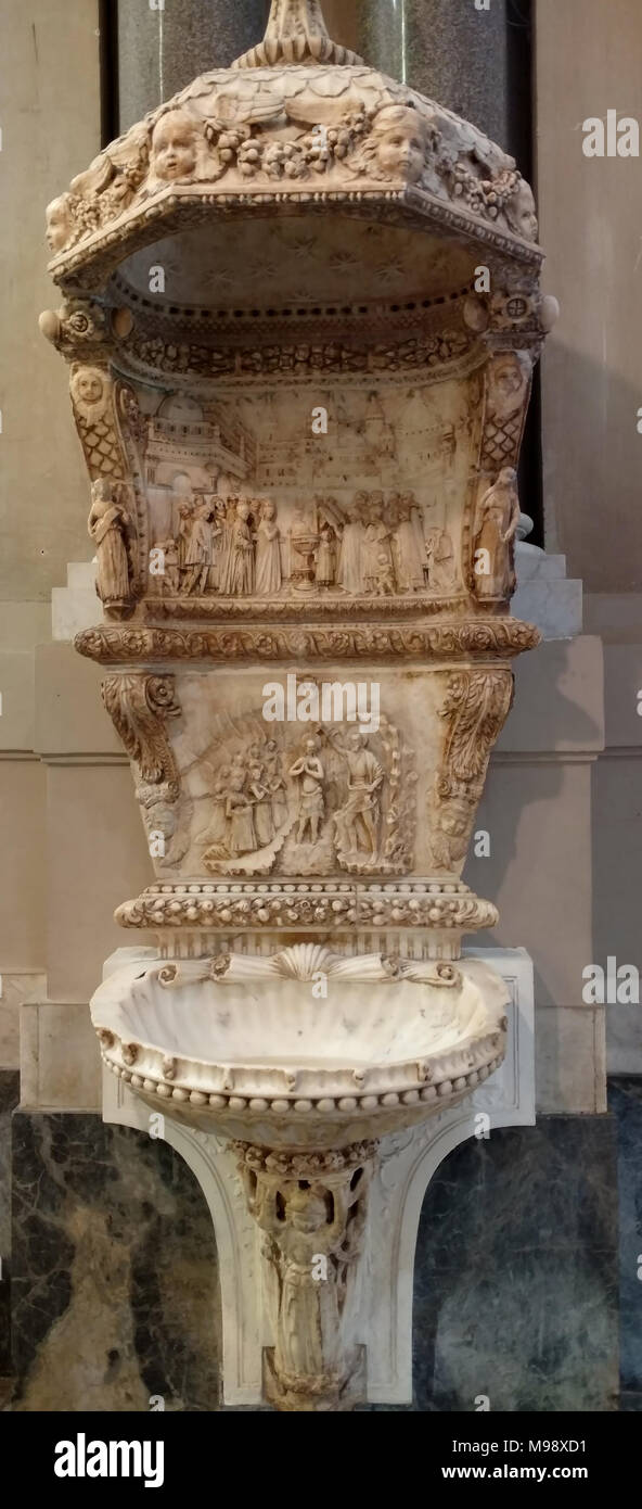 Cette photo remonte à mars 2018 à Palerme en Sicile, il montre les fonts baptismaux à l'entrée de la cathédrale. La police est attribuée à Domenico Gagini. La décharge centrale célèbre l'inauguration de la cuve baptismale avec une Renaissance imaginaire paysage urbain. Antonello Gagini n le tabernacle de la cathédrale. Il est considéré comme le meilleur sculpteur sicilien de la Renaissance. Il était le fils de Domenico, un sculpteur qui est né en 1420 à Locarno, aujourd'hui en Suisse, mais à l'époque une possession du duché de Milan. Après avoir travaillé à Florence, Gênes et Naples, il s'installe à Palerm Banque D'Images