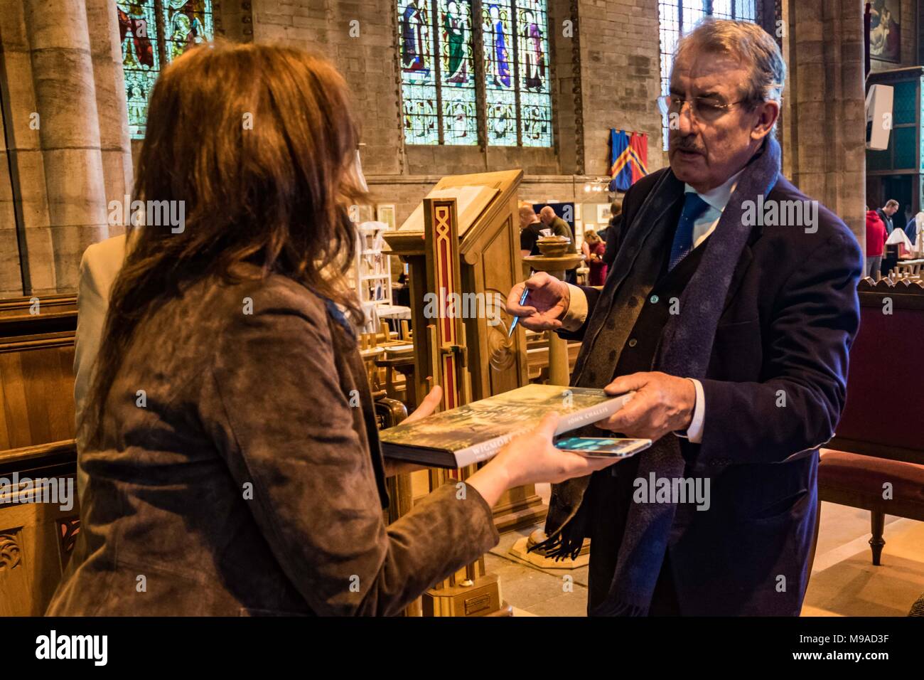 , LEOMINSTER HEREFORDSHIRE, Royaume-Uni - 24 mars : l'acteur John Challis mains sur un livre signé pour un ventilateur à la fête médiévale dans la ville de Leominster le 24 mars 2018. L'acteur qui en ce moment stars dans la série comique et Benidorm se trouve dans le Herefordshire ravi les foules qui se sont réunis pour voir l'ouverture de la fête médiévale un jour Crédit : Jim Wood/Alamy Live News Banque D'Images