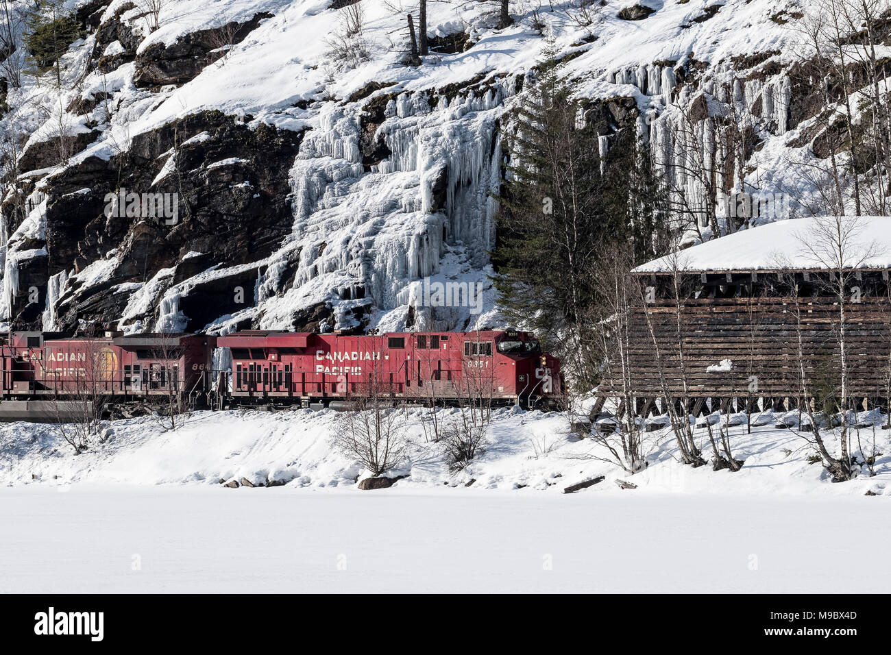 Le CFCP loco 8640 Train de charbon pousse vers l'est passé le col Rogers Glacier Station en chute de neige BC Banque D'Images