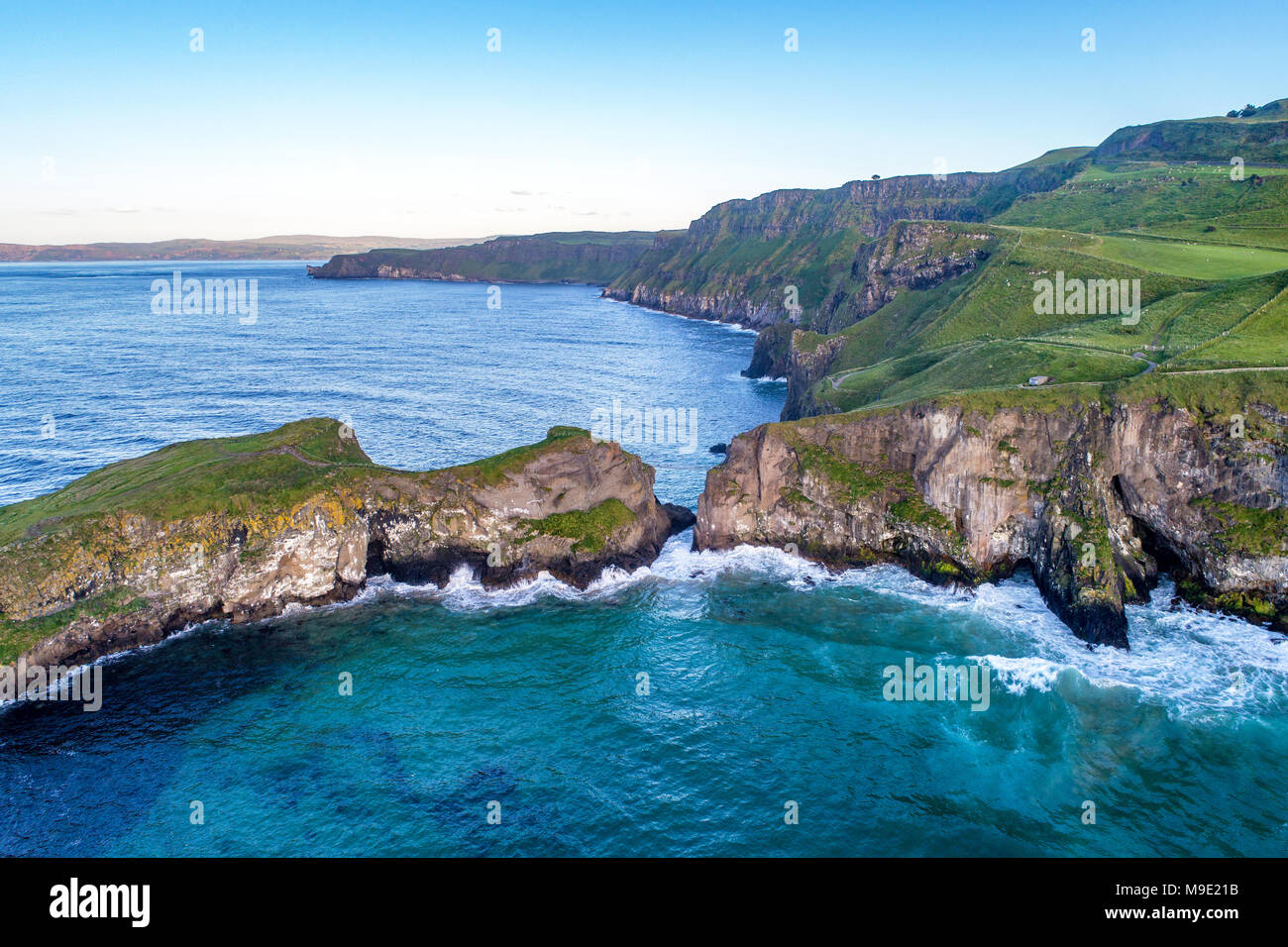L'Irlande du Nord, Royaume-Uni. La côte atlantique avec des falaises et loin vue aérienne de Carrick-a-Rede dans le comté d'Antrim Banque D'Images