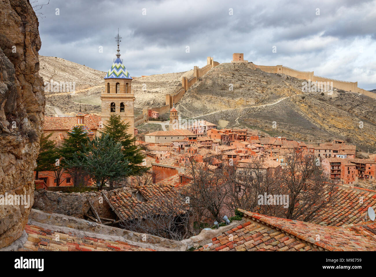 Belle vue sur la ville médiévale Albarracin, avec des collines et les remparts de la ville à l'arrière-plan sous un ciel nuageux. Teruel, Espagne. Banque D'Images