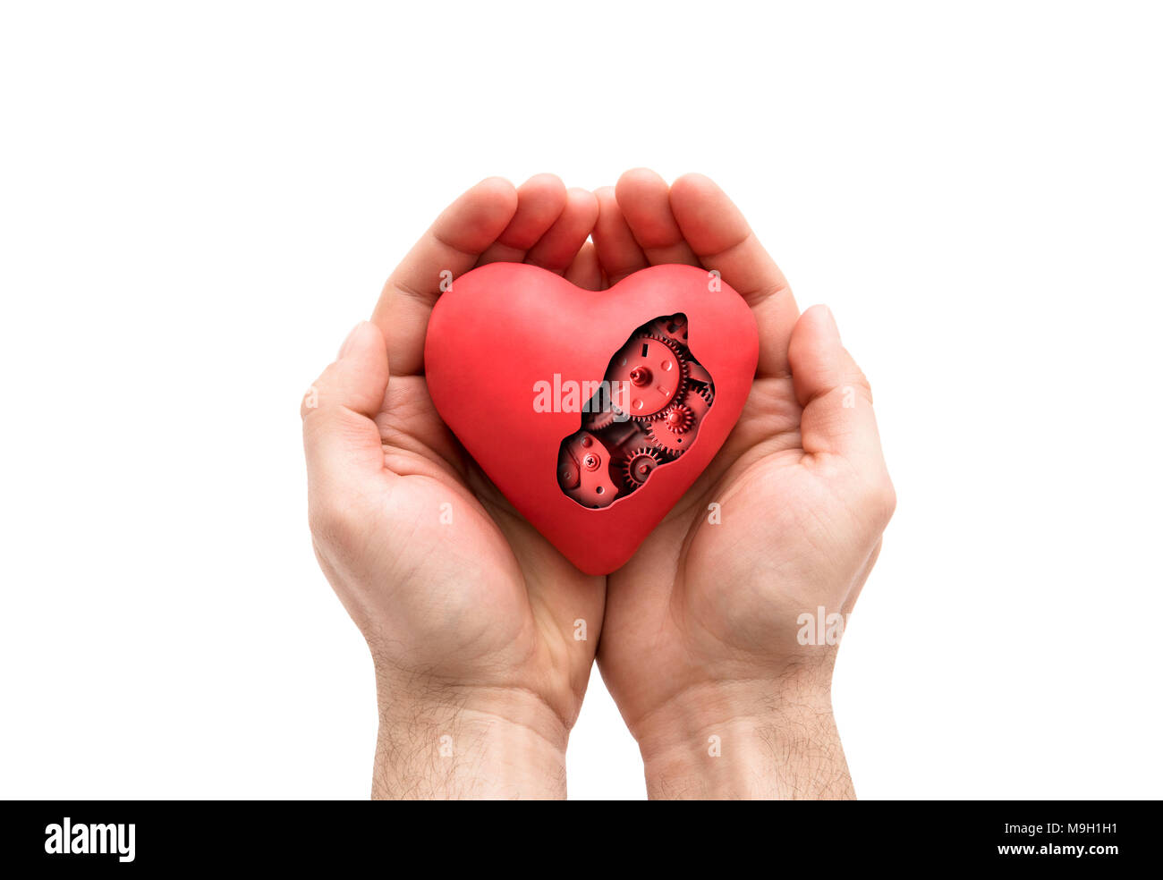 Coeur mécanique rouge en mains isolated on white with clipping path Banque D'Images