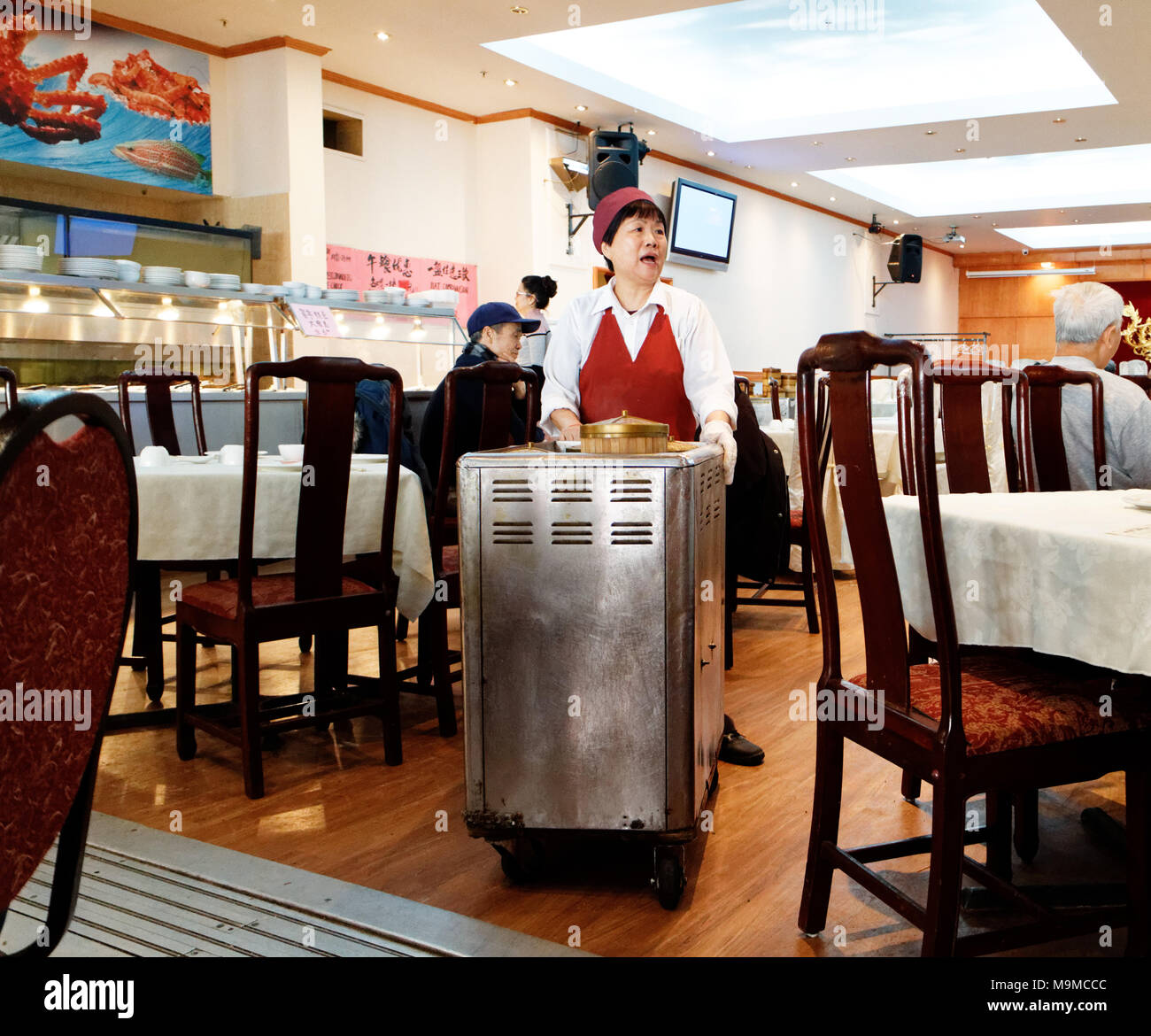 Une femme chinoise qui sert de la nourriture de ses dim sum dans le célèbre restaurant Ruby Rouge dans le quartier chinois de Montréal Banque D'Images