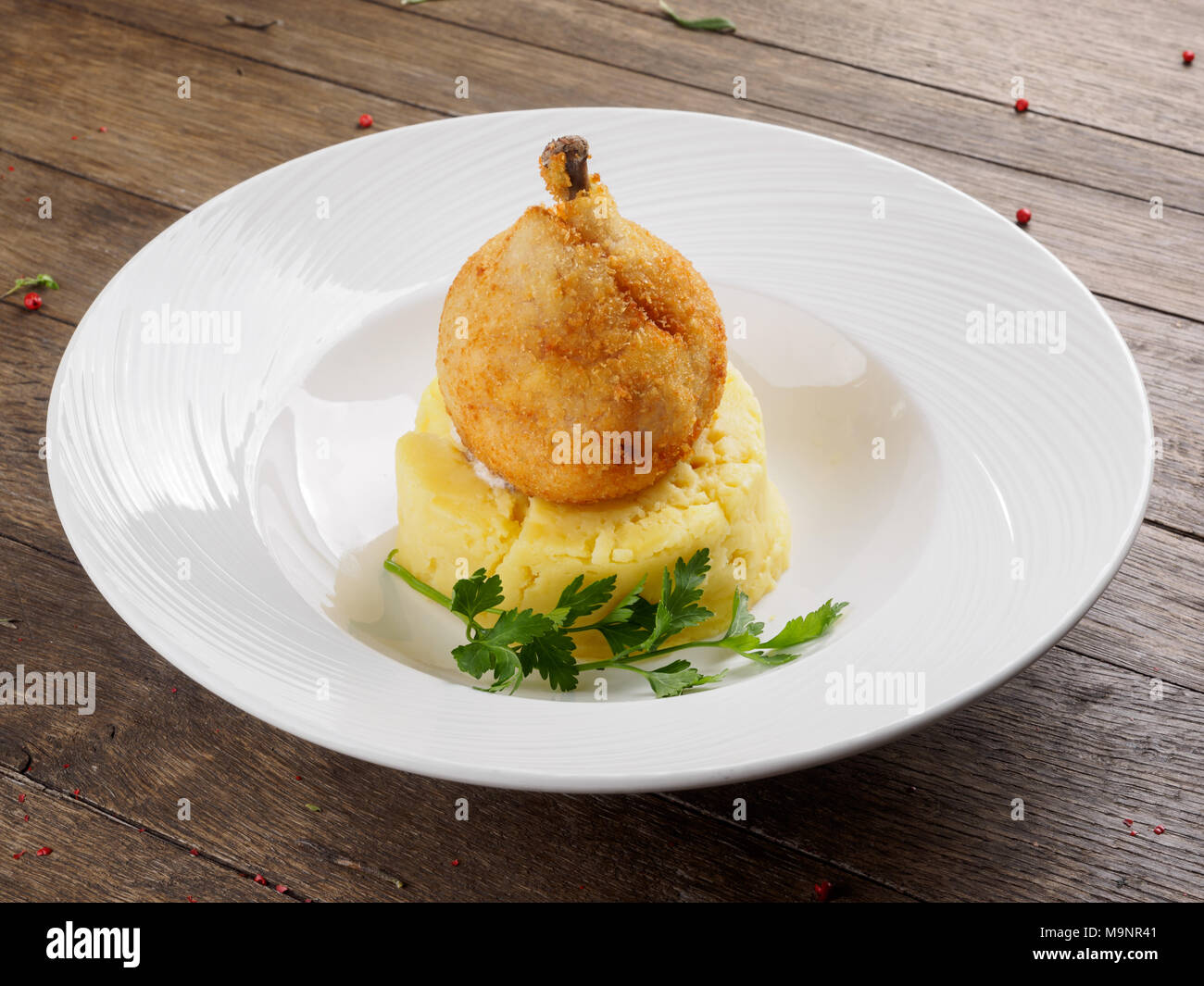 Restaurant le plat. Escalope de poulet sur un os avec de la purée de pommes de terre et une feuille de persil. Banque D'Images