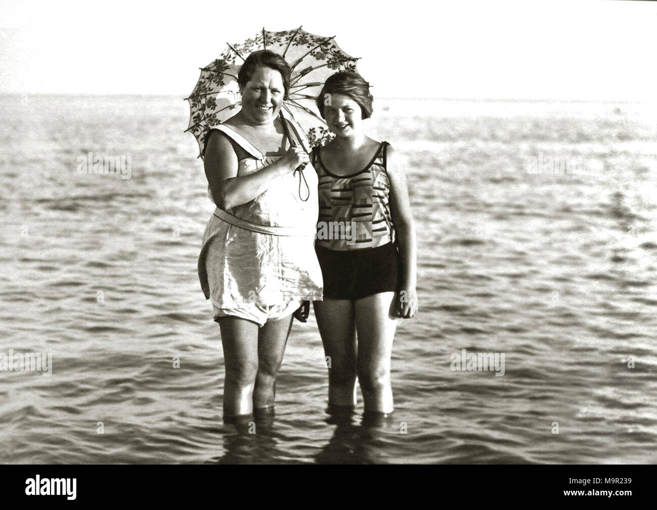 Deux femmes en maillots de bain et avec un parasol debout dans la mer, 1930, Allemagne Banque D'Images